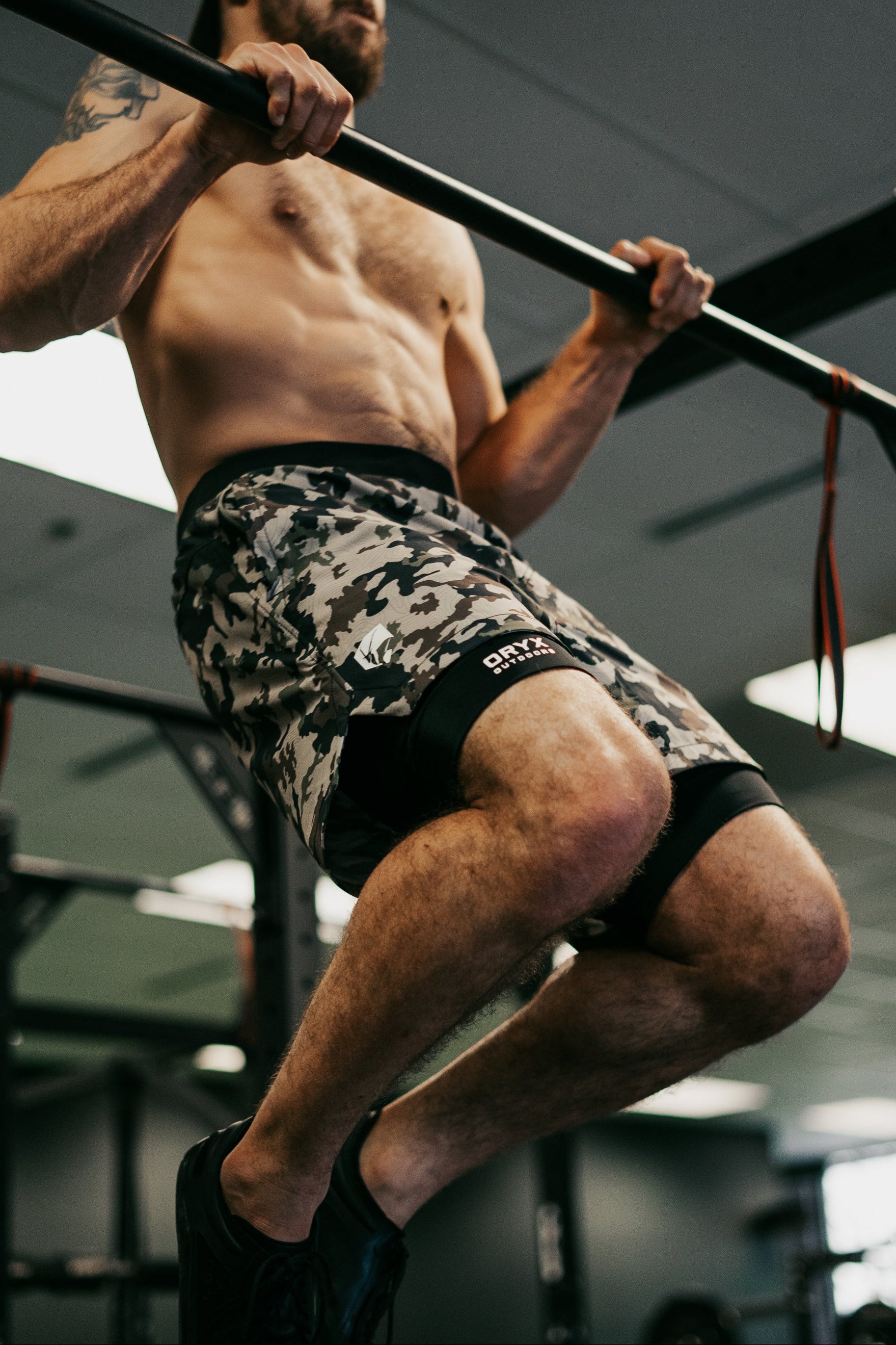 Man working out pull ups in the gym wearing Oryx Training Gym Shorts