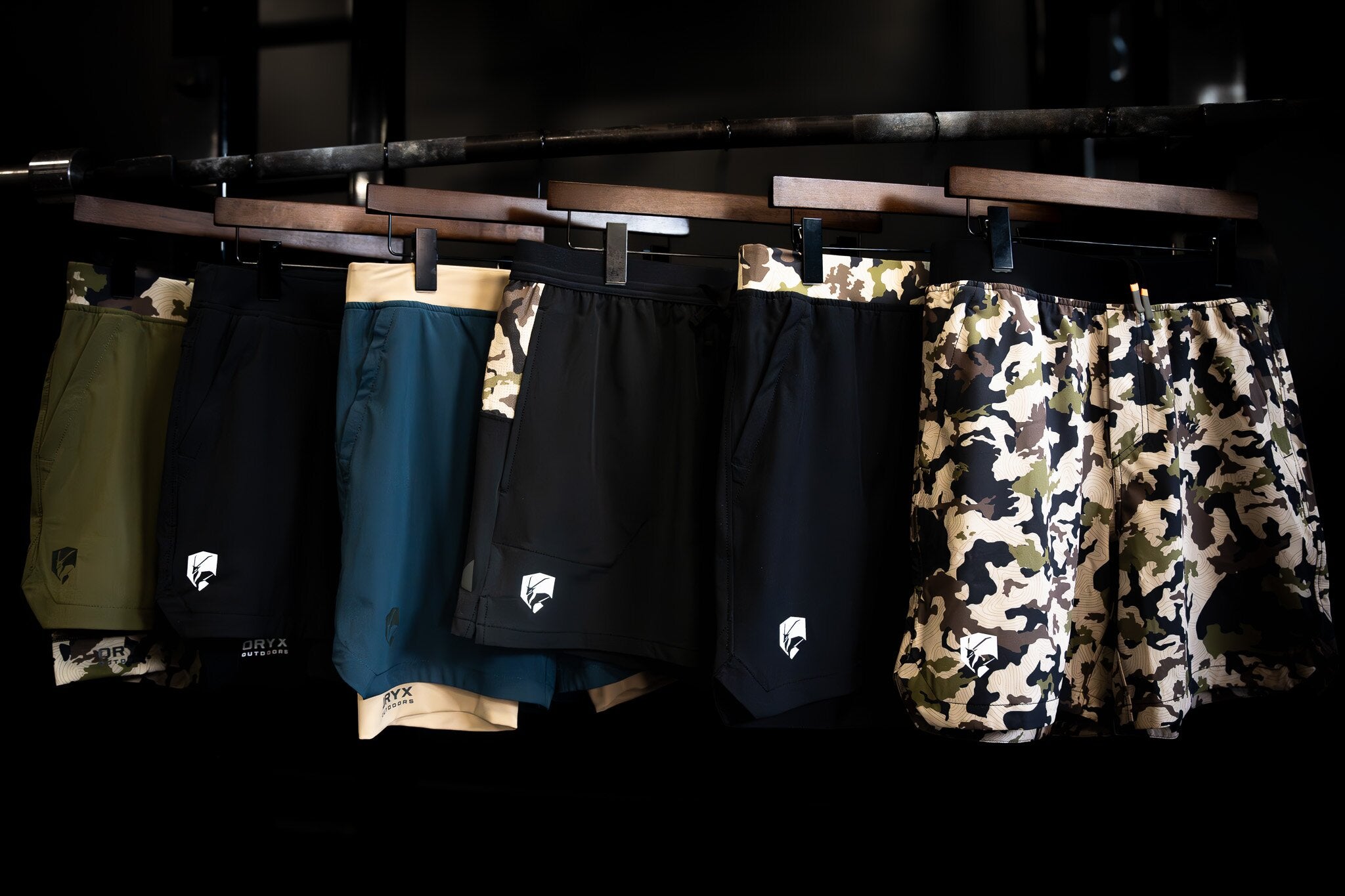 green camo training short, black compression short, blue and tan short, camo running shorts, camo shorts with compression.